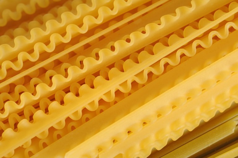 Close-up of uncooked golden spiral noodles