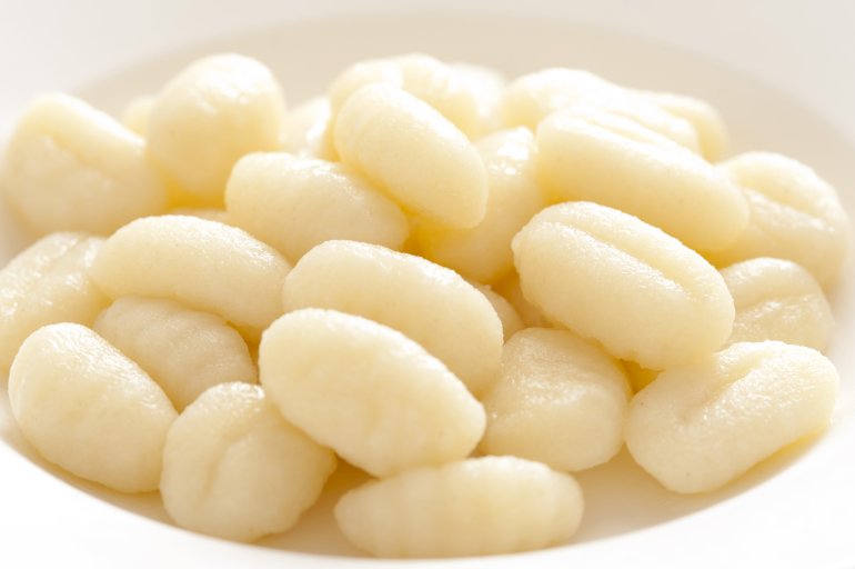 Close-up of many uncooked gnocchi on plate