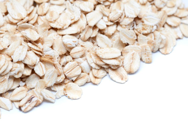 Closeup view of healthy rolled oats used as an ingredient in many cereals, in particular muesli and granola