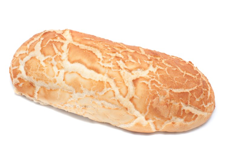 Golden freshly baked loaf of crusty bread from a bakery on a white background
