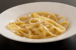 Bowl of plain cooked tagliatelle pasta