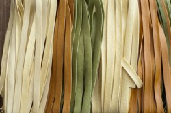 Background texture of colorful tagliatelle pasta