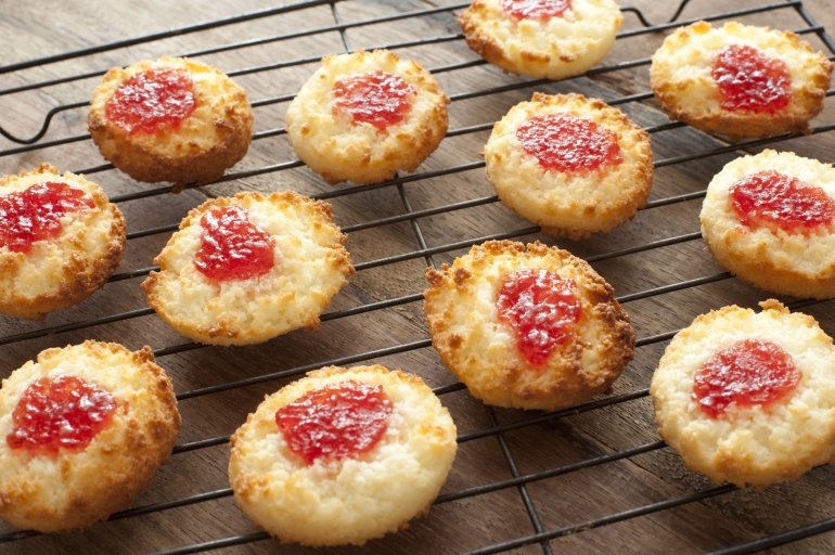 Delicious freshly baked homemade sweet strawberry jam drop cookies on baking tray over wooden table