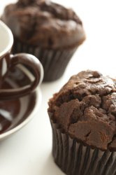 Freshly baked chocolate muffins with coffee cup