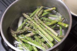 asparagus spears boiling in a pan