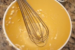 Empty yellow mixing bowl with whisk