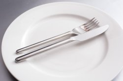 Generic knife and fork on a clean white plate