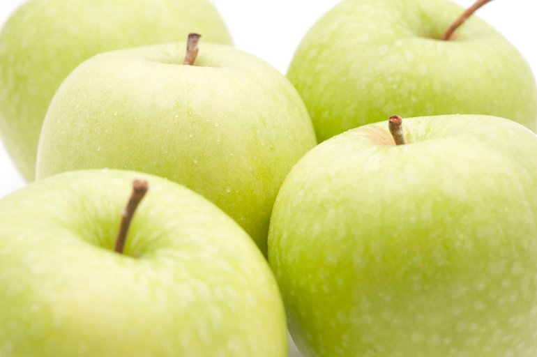 Close-up of fresh Granny Smith green apple on white background