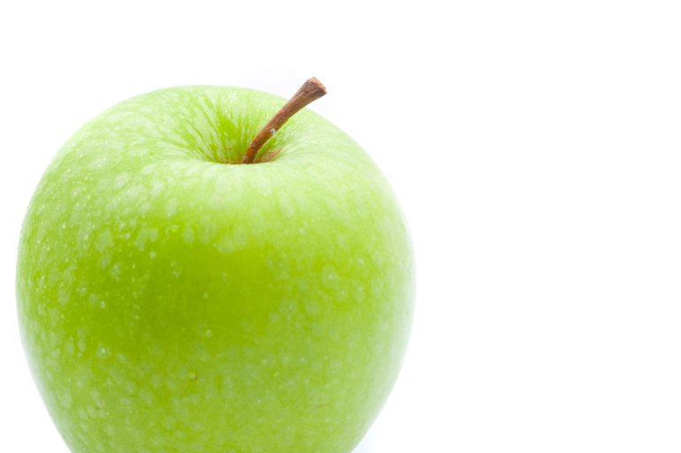 Close-up of a fresh Granny Smith green apple, on white background