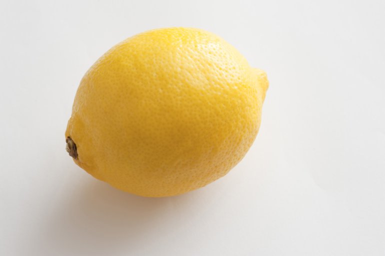 One lemon on white table. Isolated