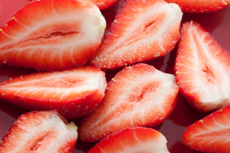Close-up of fresh tasty strawberries cut in halves