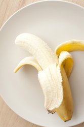 Peeled banana on a white plate