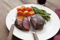 supper of medium rare steak with vegetables
