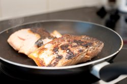 Salmon steaks searing in the pan