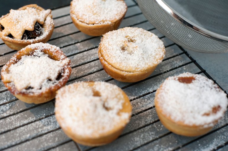 Homebaked Christmas mince pies with a traditional sweet savoury fruity filling and decorated with Christmas tree pastry, high angle view