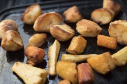 Roasting slices of potato and parsnips
