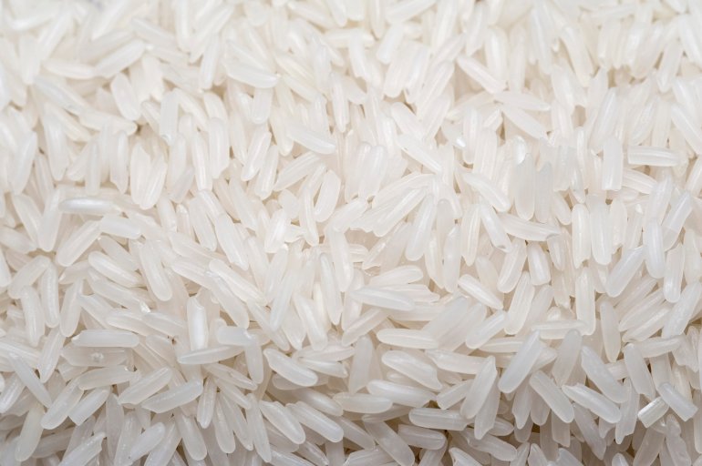 Background of aromatic long-grained basmati rice from India used as cooking ingredient in savoury dishes