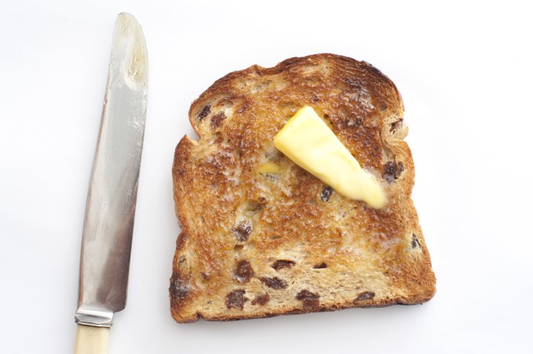 Toasted Raisin Bread with Butter and knife