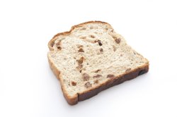 One slice of fruit bread on white background