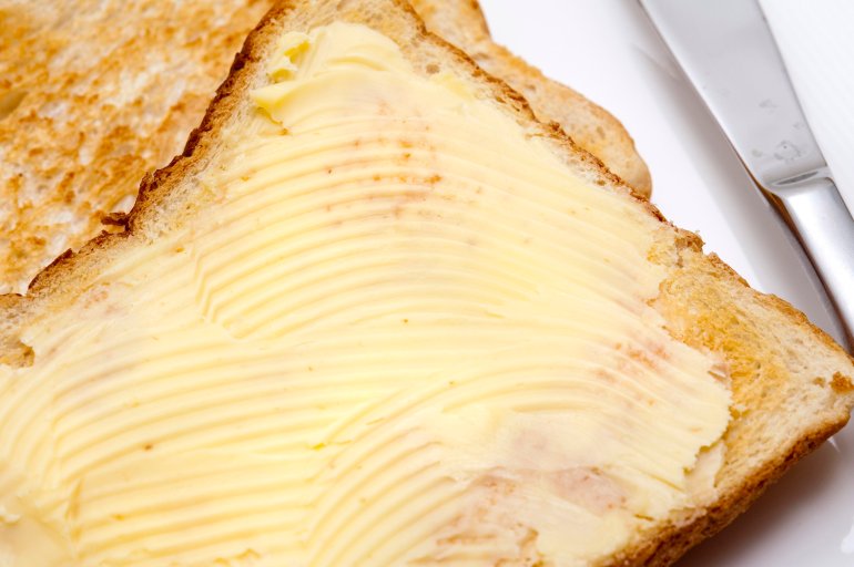 Closeup of a whole slice of buttered toast served for breakfast or as a midday snack