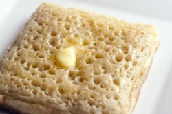 buttered crumpet on plate