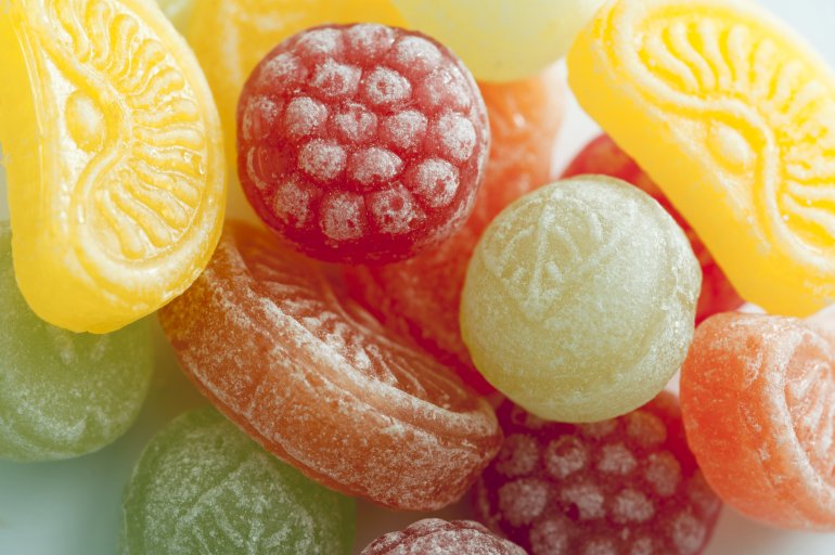 Close up on sugar sweetened lemon, raspberry, orange and lime fruit flavored candy
