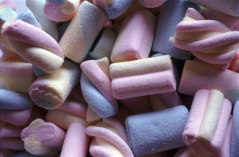 Background of soft spongy multicoloured marshmallows in a random pile