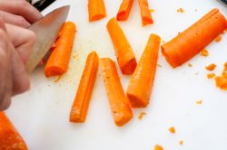 Man cutting carrot batons