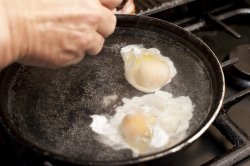 preparing two poached eggs