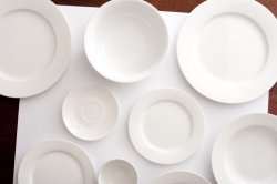 Assorted white crockery on a matching background