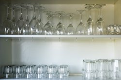 Clean glassware neatly arranged on open shelves