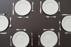 Table set with white plates and cutlery