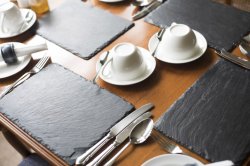 Dinner table settings with slate mats