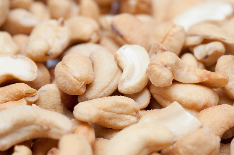 Close up view with shallow dof of fresh roasted cashew nuts served as an appetizer or snack