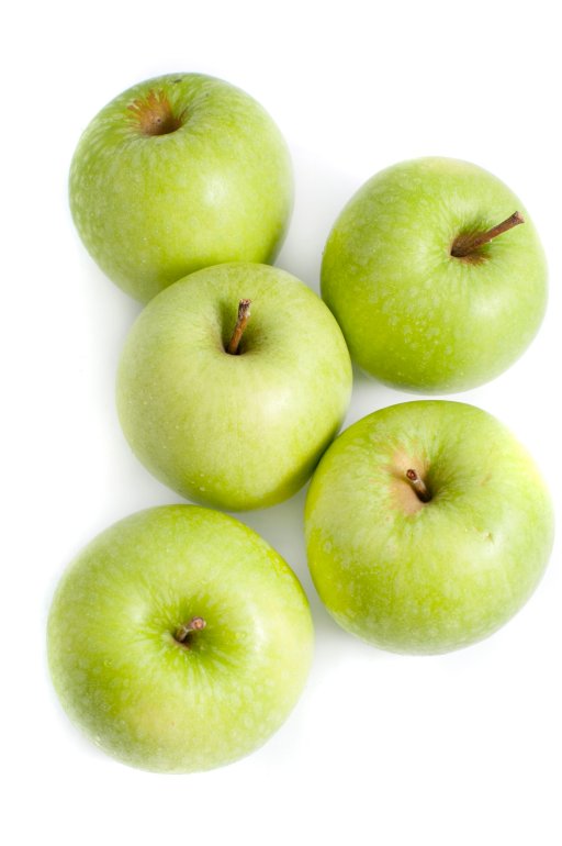 Overhead view of five crisp green apples for a healthy diet and lifestyle on a white background