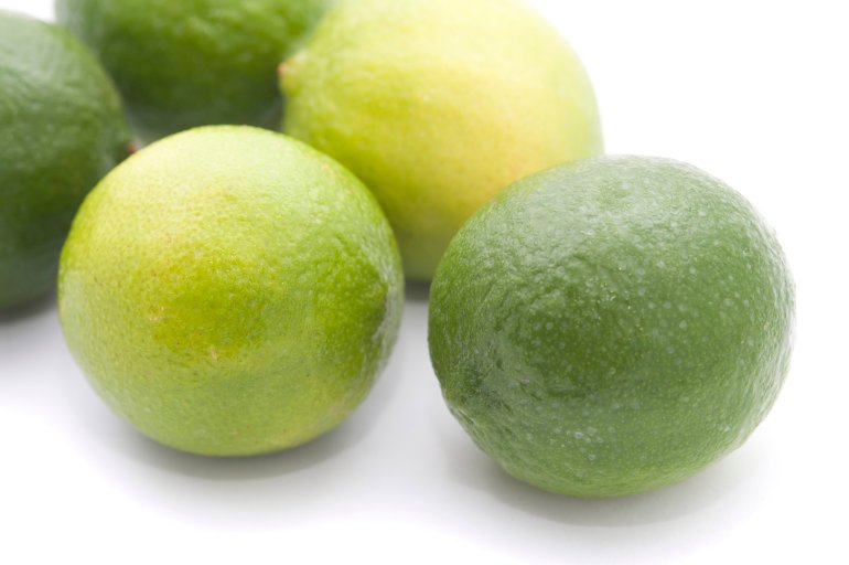Nutritious fresh and green limes on white background, close-up