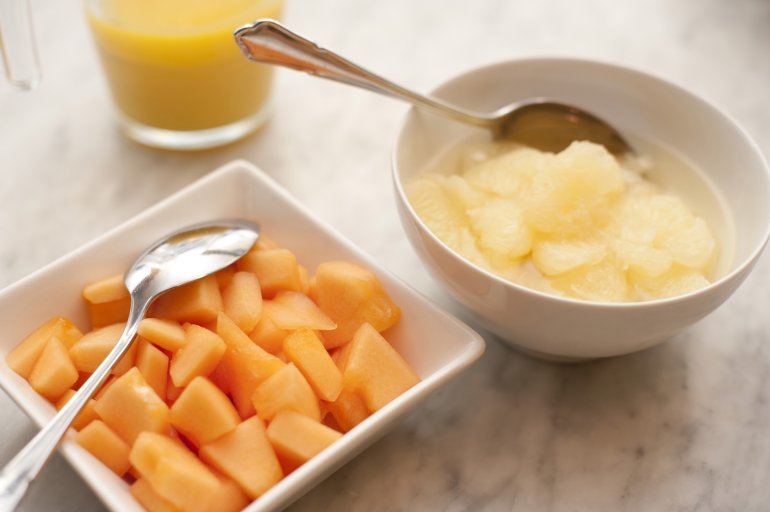 Summer breakfast: chopped papaya and pineapple in bowls