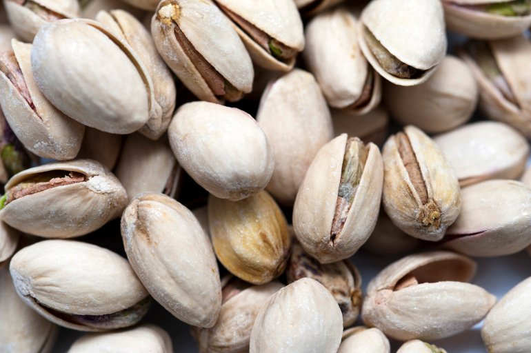 Close-up of tasty pistachios in shell as a background