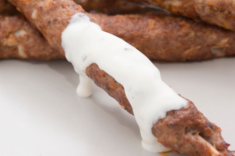 Spicy kofta kebabs made from minced lamb, spices and herbs and served with a sauce