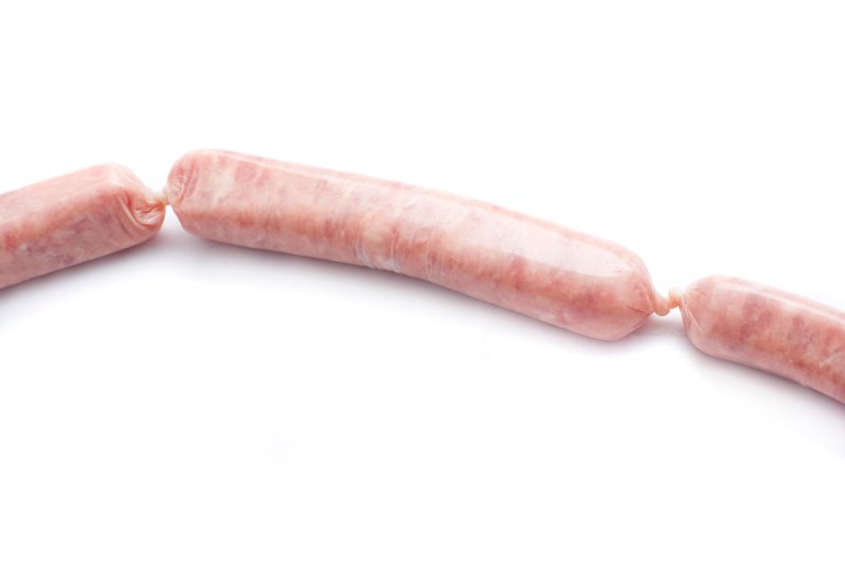 Raw pork sausage linked to two additional sausages , one on either side, over a white background