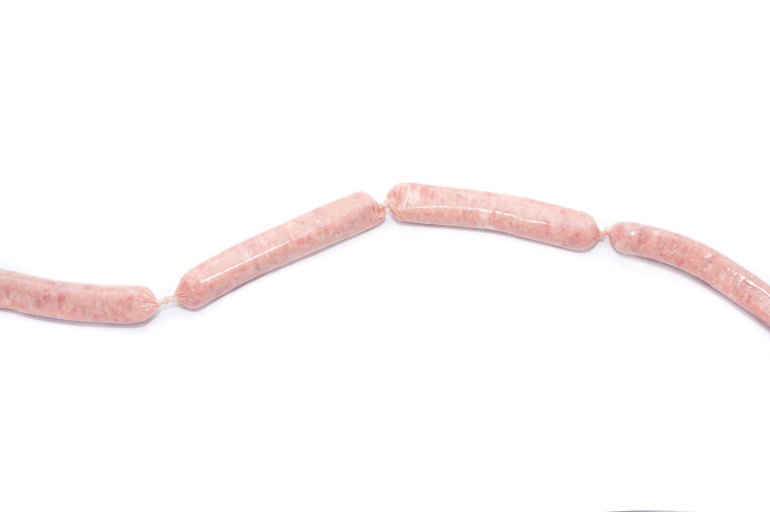 Long line of linked uncooked pork sausages for a delicious quick meal on a white background