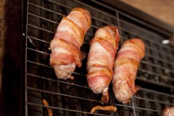 Bacon sausage rolls on grill