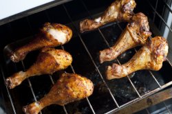 Grilled chicken legs on a roasting pan