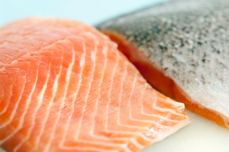 Close up of raw uncooked fresh salmon steaks showing the texture of the flesh of this seafood delicacy
