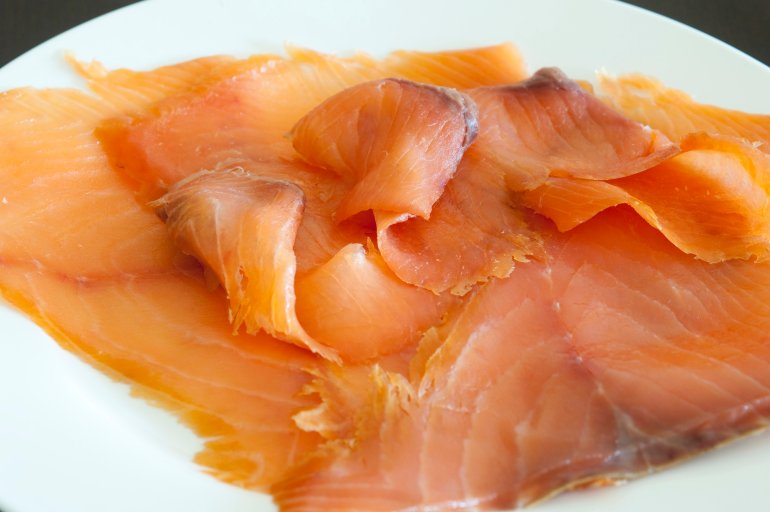 Dish of thinly sliced gourmet smoked salmon for a gourmet appetizer or seafood meal