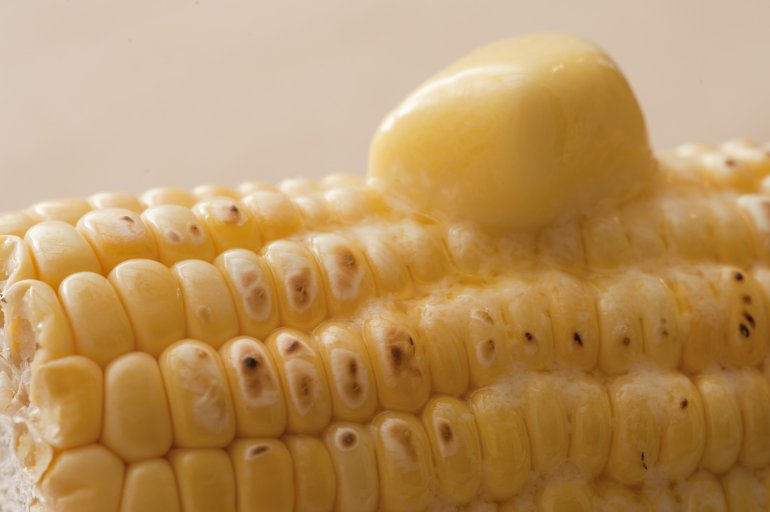 Close-up of corn cob with melting butter on top